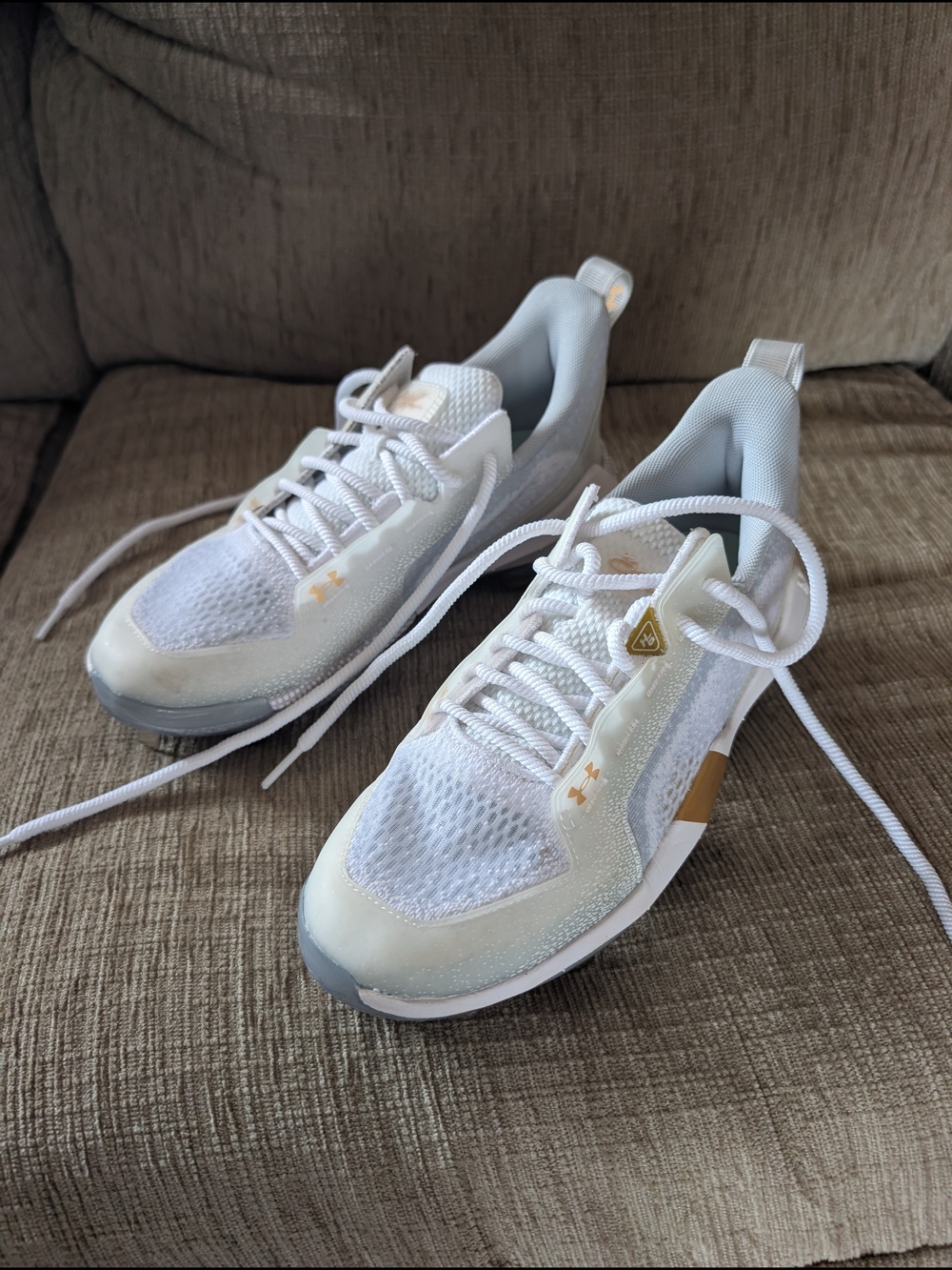 Women's White Under Armour Cleats with Gold Accents Size 6.5